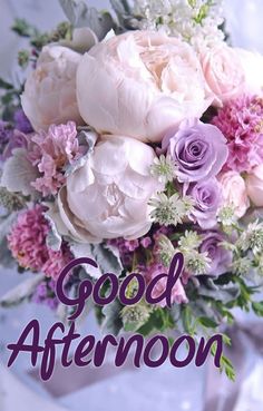 a bouquet of flowers with the words good afternoon written in purple and white on it