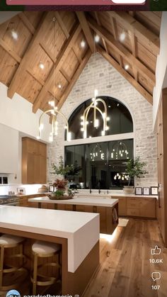 a large kitchen with wooden floors and white counter tops