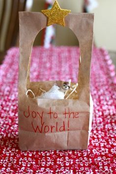 a small paper bag sitting on top of a table covered in red and white cloth