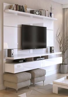 a living room filled with furniture and a flat screen tv mounted on a wall above a fireplace