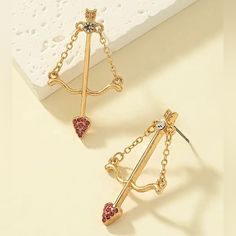 Main Material: 18k Gold Plated Zinc Alloy With Synthetic Gemstones Brand New Earring Needle Material: Iron Dimensions: L - 1.57in // W - 0.98in Bundle 2 Or More Items For A Special Discount And Save On Shipping! Yellow Gold Heart Earrings For Valentine's Day Party, Single Earring For Valentine's Day Party, Valentine's Day Dangling Charms Drop Earrings, Gold Dangle Heart Earrings For Party, Dainty Earrings For Valentine's Day Party, Valentine's Day Dangle Earrings With Dangling Charms, Valentine's Day Single Dangle Earring Jewelry, Valentine's Day Dangle Earrings With Charms, Dainty Valentine's Day Party Earrings