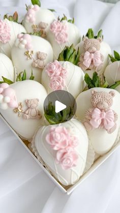 a box filled with lots of white chocolate covered in pink flowers and bowknots