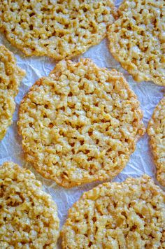 some cookies are sitting on a piece of wax paper