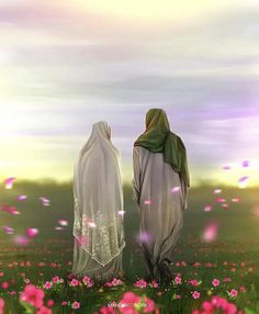 two women standing in a field with pink flowers on the ground and one is wearing a white shawl