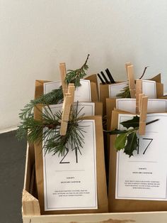 boxes filled with cards and pine branches on top of a table