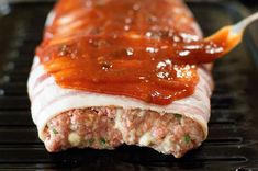 the meatloaf is covered with sauce and ready to be cooked in the oven