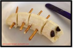 a banana cut in half with toothpicks on it