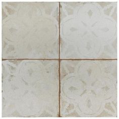 a white tile floor with four different designs on it