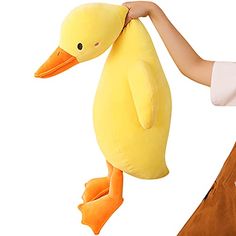 a person holding a yellow duck stuffed animal