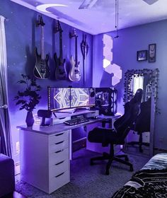 a room with purple lighting and guitars hanging on the wall, along with a computer desk