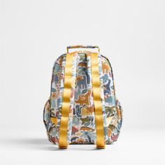 A backpack that's extra comfy and ready to handle all the adventures of the day. Decorated with colorful dino pals, a lush landscape and cheery yellow trim, this kids' small knapsack is constructed of supremely durable polyester fabric that includes recycled plastic bottles. A roomy interior holds everything your kid needs-books, school supplies, extra layers-and there's a padded pocket to keep their tablet protected. Outside pockets hold snacks, water bottles and more. Pair this book bag with t Playful Yellow Backpack For Back To School, Multicolor Backpack For Daycare, Multicolor Standard Backpack For Adventure, Multicolor Adventure Backpack, Playful Softback Travel Backpack, Playful Backpack For Daycare, Kids Pencil Case, Books School, Lush Landscape