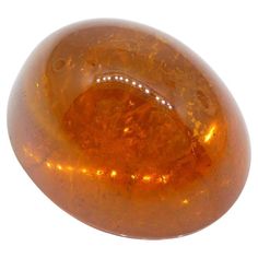 an orange glass object on a white background