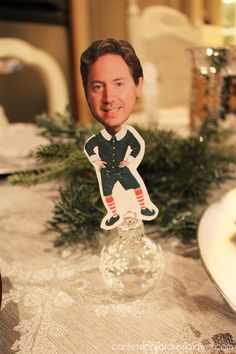 a close up of a table with a paper cut out of a man on it