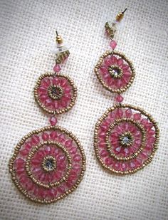 These pretty earrings are made entirely of beads. They measure 3 and one-quarter inches long. The bottom circles measure 1 and one-half inches in diameter. They are in good condition and truly unique. Thanks for looking! Pink Round Beaded Earrings With Dangling Beads, Handmade Pink Circular Earrings, Handmade Pink Circle Earrings, Bohemian Pink Beaded Earrings, Bohemian Gold Beaded Round Earrings, Bohemian Gold Beaded Earrings, Bohemian Gold Beaded Circle Earrings, Pink Gold Beaded Drop Earrings, Pink Bohemian Beaded Earrings For Festive Occasions