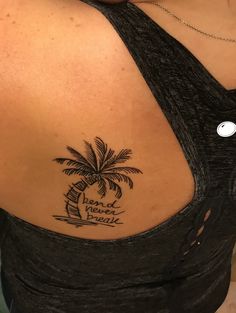 a woman with a palm tree tattoo on her back