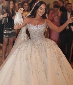 a woman in a wedding dress is dancing on the dance floor