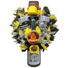 a bouquet made up of various items in yellow and black colors with an orange hat on top