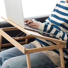 a person sitting on a couch using a laptop