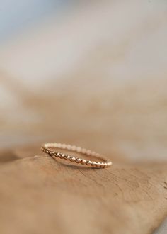 Wear them individually for a simple adornment, or stack them for a stronger statement. 1.5mm band width. Shown with our Demi Hand Chain, Sunny Ring and Midi Wrap Ring. We love all of our stacking bands, but we really love this with our Teeny-Tiny Bands, Aden Band and Confetti Ring. Handmade in Eau Claire, WI. All of our jewelry is handmade to order so each piece will be unique and may vary slightly from what is pictured. Confetti Ring, Everyday Wear Jewelry, Beaded Ring, Stacking Bands, Wrap Ring, Cuff Rings, Handmade Jewelry Designs, Hand Chain, Wrap Rings