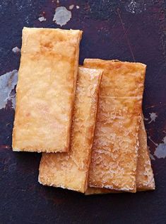 three pieces of food sitting on top of a table