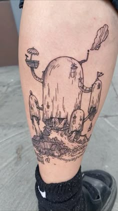 a person with a tattoo on their leg that has an image of a whale in the water