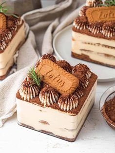 a piece of cake on a plate with some other desserts in front of it