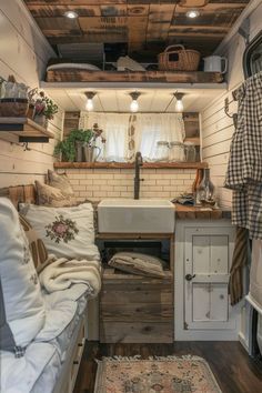 the interior of an rv with white walls and wood flooring is decorated in rustic style