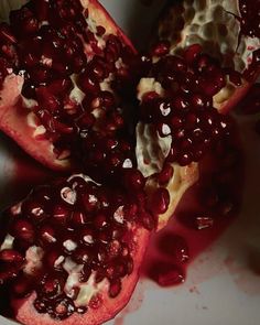 the pomegranate is cut in half and ready to be eaten