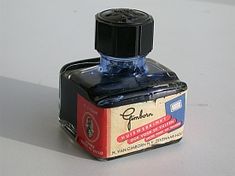 a bottle of ink sitting on top of a table