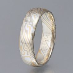 This classic woodgrain pattern mokume gane ring is 7mm wide, smooth, and made with 14k palladium white gold, 18k yellow gold and sterling silver - my personal favorite color combination.Prices quoted are good for sizes up to 9.75 - please contact me for a quote for larger sizes.Add-on:Stones and cost of setting not included, please contact me for a custom quote - I can set any stone you provide, 3-6mm in width, or I can provide a stone for you. I recommend a stone with MOHS hardness of at least Mokume Gane Ring, Gold And Silver Ring, Damascus Ring, Woodgrain Pattern, Mokume Gane, Custom Wedding Rings, Gold And Silver Rings, One Ring, Gold Style