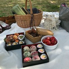 some food is sitting out on a table with strawberries and other foods in bowls