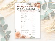 a baby shower price is right sign next to some leaves and flowers on a white background