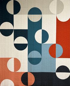 an abstract quilt with circles and lines on it's sides, in shades of blue, red, orange, and white