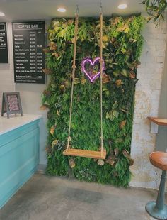 a green wall with a purple heart hanging from it's side in front of a counter