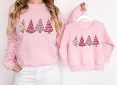 "Mommy and Me Christmas Sweatshirt, Pink Christmas Sweaters, Matching Mom and Me Christmas, Matching Christmas Shirt, Christmas Outfit **PLEASE NOTE: THIS IS NOT A SET - SWEATSHIRTS MUST BE PURCHASED SEPARATELY IN ORDER TO RECEIVE BOTH MAMA AND MINI SWEATSHIRTS. IF YOU HAVE ANY QUESTIONS FEEL FREE TO REACH OUT ANYTIME AND WE WILL BE HAPPY TO ASSIST YOU. H O W T O O R D E R 1. Simply select the size of your hoodie individually and then click \"Add to Cart\" 2. Repeat each step for each hoodie tha Matching Christmas Shirts, Christmas Sweaters For Women, Matching Mom, Christmas Tree Shirt, Christmas Crewneck, 80s Outfit, Pink Christmas Tree, Mini Christmas, Winter Sweatshirt