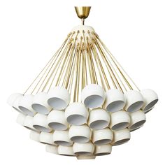 a chandelier made out of white ceramic balls and gold colored metal rods on a white background