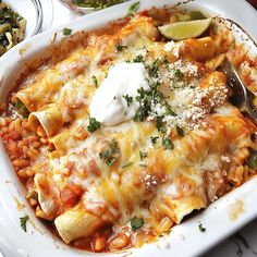 a white plate topped with lasagna covered in sauce and cheese