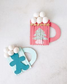 two popsicle crafts, one with a christmas tree and the other with marshmallows