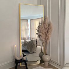 a living room with a large mirror and candles