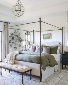 a bedroom with a canopy bed and white walls