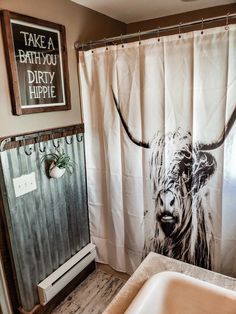 a bathroom with a shower curtain, sink and bathtub