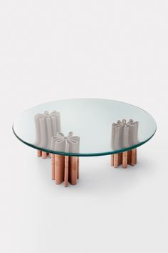 a glass table with two candles on it