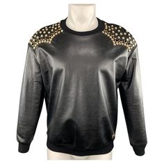 JUST CAVALLI western pullover comes in black coated leather effect cotton jersey with a ribbed crew neck and gold tone black and clear rhinestone studded shoulders. Made in Italy. Excellent Pre-Owned Condition. Marked: IT 44 Measurements: Shoulder: 22 inches Chest: 46 inches Sleeve: 21 inches Length: 26.5 inches Reference: 98244 Category: Sweatshirt More Details Brand: JUST CAVALLI Size: 34 Color: Black Pattern: Studded Fabric: Coated Cotton Style: Crew-Neck Age Group: Adult Gender: Male Luxury Crew Neck Top For Fall, Luxury Black Sweatshirt For Fall, Luxury Streetwear Tops For Fall, Luxury Fall Streetwear Tops, Luxury Long Sleeve Tops For Streetwear, Gold Crew Neck Sweatshirt For Fall, Yellow Cardigan, Belted Cardigan, Rhinestone Studs