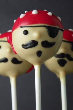 three cake pops with black and white frosting on them