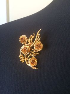 Beautiful vintage Coro brooch in gold tone and rose bouquet design.  Signed Coro. Measures about 2 1/8 inches by 1 ¼ inches.In very good vintage condition.Please see this section of my shop for more vintage costume jewelry: https://www.etsy.com/shop/ChrisandTine?section_id=17309162My full shop: http://www.chrisandtine.etsy.comPrices are listed for Canada and USA only but if you wish to have them shipped elsewhere, please message me the shipping address and I will gladly send you a quote. Vintage Rose Gold Brooches For Wedding, Formal Gold Brooch With Rose Design, Vintage Rose Gold Wedding Brooches, Vintage Gold Brooches With Intricate Design, Elegant Yellow Gold Cameo Brooch, Vintage Gold-tone Brooches For Formal Occasions, Vintage Rose Flower Brooch, Bouquet Brooch, Gold Flower-shaped Brooches With Rhinestones