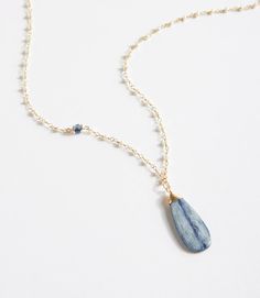 A pearl gemstone chain is accented by a pop of kyanite on this handcrafted necklace. The focal is a simple kyanite teardrop, wrapped by hand in gold filled wire. Gemstone Necklace Ideas, 2024 Jewelry, Kyanite Necklace, Kyanite Earrings, Gemstone Pendant Necklace, Jewelry Men, Handcrafted Bracelets, Handcrafted Necklace, Stone Pendant Necklace