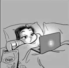 a person laying in bed with a laptop on their lap and chips next to them