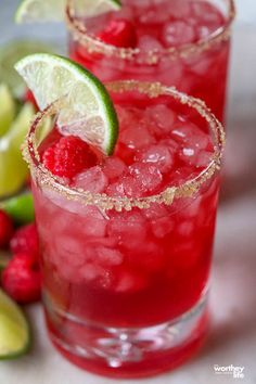 two glasses filled with raspberry lime margaritas