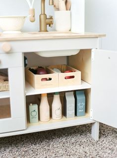 a white cabinet with some bottles and containers on it