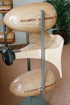 a model of a musical instrument made out of plywood and metal pipes, on display in an office building